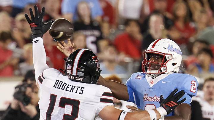 Oct 4, 2025; Houston, Texas, USA; Houston Cougars quarterback Zeon Chriss (2) passes against Texas Tech Red Raiders linebacker Ben Roberts (13) in the second half  at TDECU Stadium. Mandatory Credit: Thomas Shea-Imagn Images