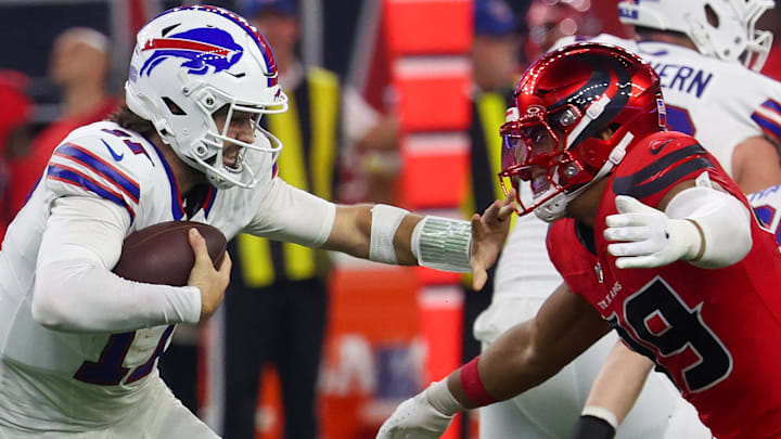 Nov 20, 2025; Houston, Texas, USA;Buffalo Bills quarterback Josh Allen (17) stiff arms Houston Texans linebacker Henry To'oTo'o (39)  in the second half at NRG Stadium. Mandatory Credit: Thomas Shea-Imagn Images