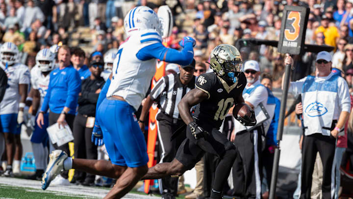 Wake Forest wide receiver Chris Barnes tries to avoid the tackle by the SMU defense. Wake Forest wide receiver Chris Barnes tries to avoid the tackle by the SMU defense.