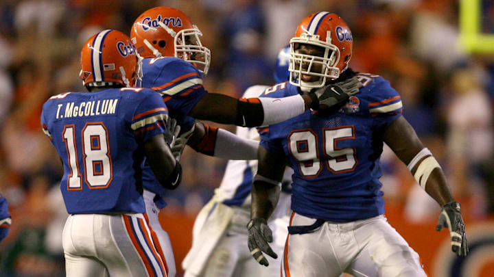 Sep 23, 2006; Gainesville, FL, USA; Florida Gators defensive end (95) Ray McDonald celebrates with teammates (18) Tremaine McCollum and (40) Brandon Siler after a sack against the Kentucky Wildcats during the 1st quarter at Ben Hill Griffin Stadium in Gainesville, FL. Mandatory Credit: Jason Parkhurst-Imagn Images Copyright © 2006 Jason Parkhurst