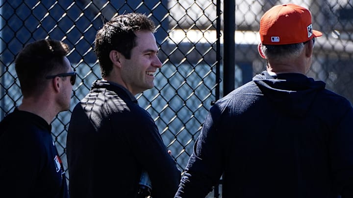 Detroit Tigers president of baseball operation Scott Harris, center, talks to manager A.J. Hinch as they watch batting practice during spring training at TigerTown in Lakeland, Fla. on Monday, Feb. 17, 2025.