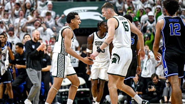 Michigan State's Divine Ugochukwu, left, celebrates with Carson Cooper after Ugochukwu's assist to Jordan Scott during the second half against Duke on Saturday, Dec. 6, 2025, at the Breslin Center in East Lansing.