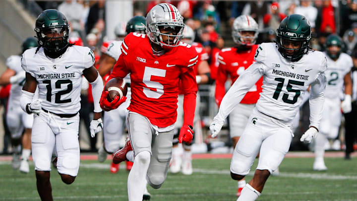Sat., Nov. 20, 2021; Columbus, Ohio, USA; Ohio State Buckeyes wide receiver Garrett Wilson (5) runs the ball during the first quarter of a NCAA Division I football game between the Ohio State Buckeyes and the Michigan State Spartans at Ohio Stadium. Mandatory Credit: Joshua A. Bickel/Columbus Dispatch via USA TODAY Network.

Wilson 1