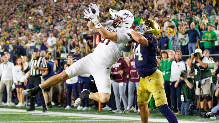 Texas A&M tight end Nate Boerkircher, left, catches a pass in the end zone to tie the game with Notre Dame linebacker Drayk Bowen, right, defending in the second half of a NCAA football game at Notre Dame Stadium on Saturday, Sept. 13, 2025, in South Bend. The extra point scored after this touchdown put Texas A&M ahead 41-40 to win the game.