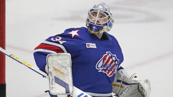 Rochester goaltender Dustin Tokarski watches as his save goes high up over the glass during warm ups