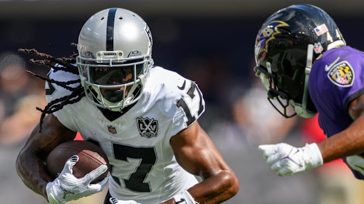 Sep 15, 2024; Baltimore, Maryland, USA; Las Vegas Raiders wide receiver Davante Adams (17) runs with the ball as Baltimore Ravens cornerback Marlon Humphrey (44) defends during the second half at M&T Bank Stadium. Mandatory Credit: Reggie Hildred-Imagn Images