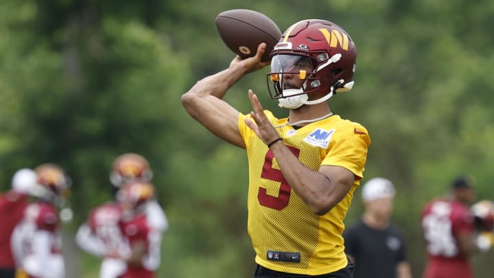 Jun 5, 2024; Ashburn, VA, USA; Washington Commanders quarterback Jayden Daniels (5) passes a ball during an OTA workout at Commanders Park. Mandatory Credit: Geoff Burke-USA TODAY Sports