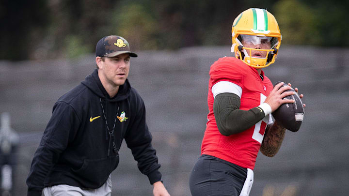 Oregon quarterback Dillon Gabriel throws out a pass as offensive coordinator Will Stein during practice with the Oregon Ducks on Tuesday, Aug. 27, 2024, at the Hatfield-Dowlin Complex in Eugene, Ore.