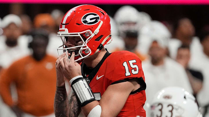 Georgia quarterback Carson Beck puts in his mouth grad on the final play during overtime of the SEC championship game against Texas.