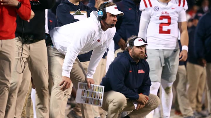 Nov 23, 2023; Starkville, Mississippi, USA; Mississippi Rebels head coach Lane Kiffin (left) and