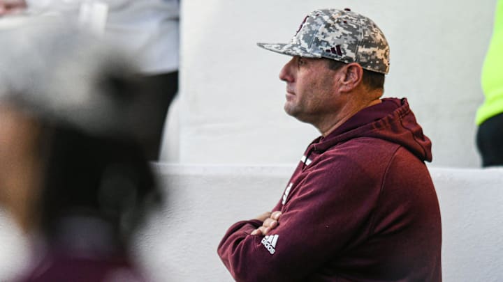 Mississippi State head coach Chris Lemonis watches from the dugout against Ole Miss at Swayze Field in Oxford, Miss., on Friday, Apr. 12, 2024.