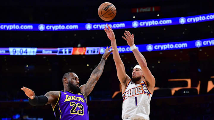 Jan 11, 2024; Los Angeles, California, USA; Phoenix Suns guard Devin Booker (1) shoots against Los Angeles Lakers forward LeBron James (23) during the first half at Crypto.com Arena. Mandatory Credit: Gary A. Vasquez-Imagn Images Jan 11, 2024; Los Angeles, California, USA; Phoenix Suns guard Devin Booker (1) shoots against Los Angeles Lakers forward LeBron James (23) during the first half at Crypto.com Arena. Mandatory Credit: Gary A. Vasquez-Imagn Images