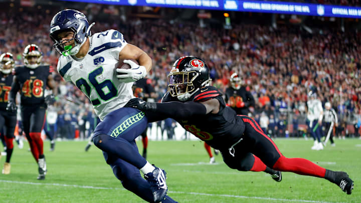 Seattle Seahawks running back Zach Charbonnet (L) and San Francisco 49ers safety Malik Mustapha (R) Seattle Seahawks running back Zach Charbonnet (L) and San Francisco 49ers safety Malik Mustapha (R)