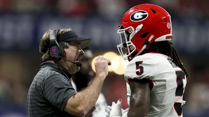 Dec 4, 2021; Atlanta, GA, USA; Georgia Bulldogs head coach Kirby Smart talks to defensive back Kelee Ringo (5) after an Alabama Crimson Tide touchdown during the SEC championship game at Mercedes-Benz Stadium. Alabama won 41-24. Mandatory Credit: Gary Cosby Jr.-Imagn Images