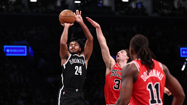 Nov 1, 2024; Brooklyn, New York, USA; Brooklyn Nets guard Cam Thomas (24) makes a three point basket during the fourth quarter as Chicago Bulls guard Josh Giddey (3) defends at Barclays Center. Mandatory Credit: Vincent Carchietta-Imagn Images