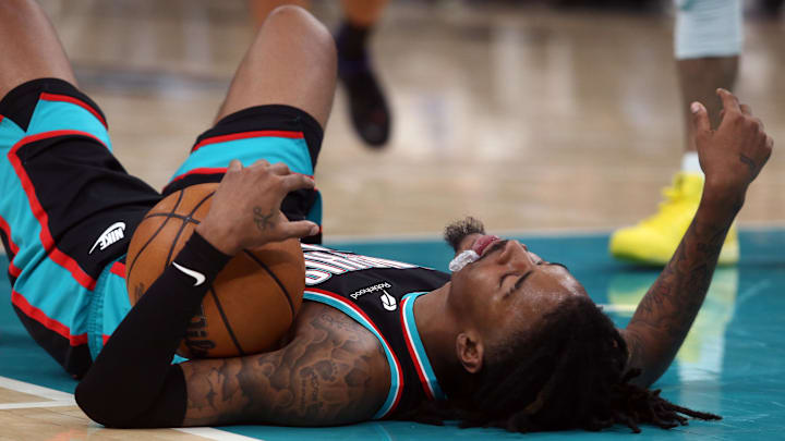 Nov 9, 2025; Memphis, Tennessee, USA; Memphis Grizzlies guard Ja Morant (12) lays on the court during the third quarter against the Oklahoma City Thunder at FedExForum. Mandatory Credit: Petre Thomas-Imagn Images