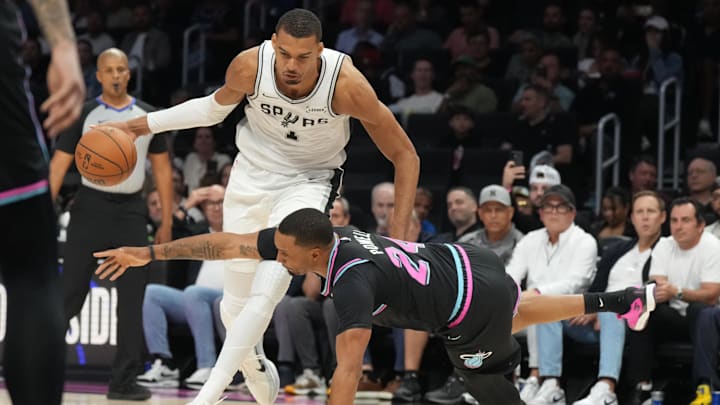 Mar 23, 2026; Miami, Florida, USA;  Miami Heat guard Norman Powell (24) falls down as San Antonio Spurs forward Victor Wembanyama (1) drives to the basket during the second half at Kaseya Center. Mandatory Credit: Jim Rassol-Imagn Images