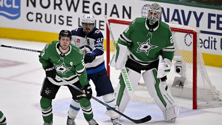 May 17, 2025; Dallas, Texas, USA; Winnipeg Jets center Mark Scheifele (55) checks Dallas Stars defenseman Esa Lindell (23) as goaltender Jake Oettinger (29) looks on during the first period in game six of the second round of the 2025 Stanley Cup Playoffs at American Airlines Center. Mandatory Credit: Jerome Miron-Imagn Images
