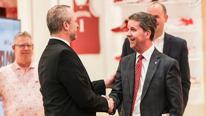 New Indiana basketball coach Darian DeVries (left) shakes hands with Indiana athletic director Scott Dolson.