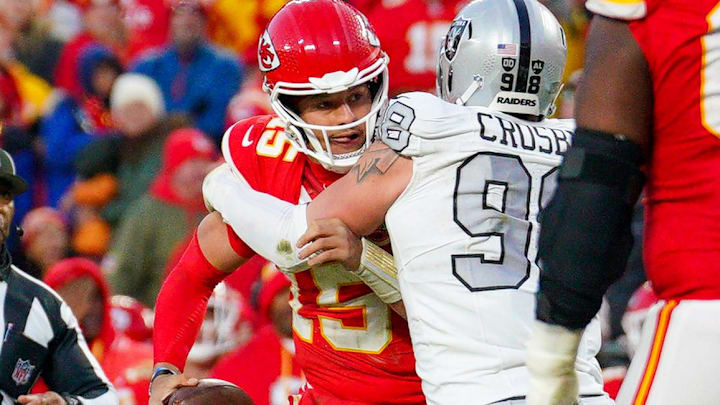 Nov 29, 2024; Kansas City, Missouri, USA; Kansas City Chiefs quarterback Patrick Mahomes (15) is sacked by Las Vegas Raiders defensive end Maxx Crosby (98) during the second half at GEHA Field at Arrowhead Stadium. Mandatory Credit: Denny Medley-Imagn Images