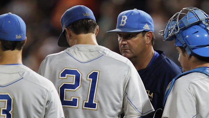 June 17, 2012; Omaha, NE, USA;  UCLA Bruins head coach John Savage talks to pitcher Nick Vander Tuig (21) during the game against the Arizona Wildcats during the seventh inning of game six of the 2012 College World Series at TD Ameritrade Park. Arizona won 4-0. Mandatory Credit: Bruce Thorson-Imagn Images