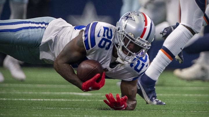 Nov 7, 2021; Arlington, Texas, USA; Dallas Cowboys cornerback Jourdan Lewis (26) makes an interception against Denver Broncos during the second quarter at AT&T Stadium. The call is overturned by a penalty. Mandatory Credit: Jerome Miron-Imagn Images
