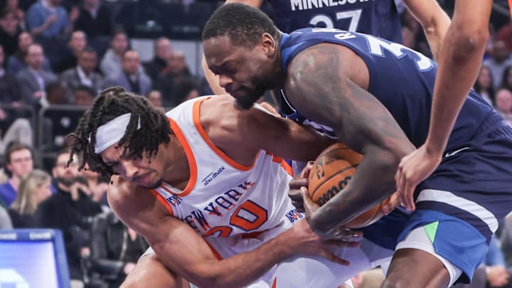 Jan 17, 2025; New York, New York, USA; New York Knicks center Jericho Sims (20) and Minnesota Timberwolves forward Julius Randle (30) fight for a loose ball in the first quarter at Madison Square Garden. Mandatory Credit: Wendell Cruz-Imagn Images