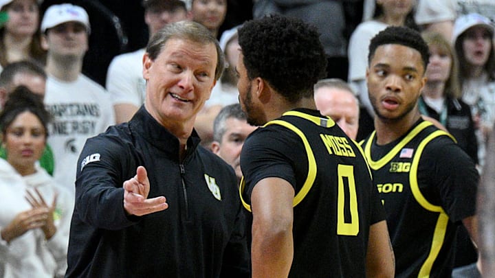 Feb 8, 2025; East Lansing, Michigan, USA; Oregon Ducks head coach Dana Altman talks to Oregon Ducks guard Ra'Heim Moss (0) during the first half against the Michigan State Spartans at Jack Breslin Student Events Center. Mandatory Credit: Dale Young-Imagn Images Feb 8, 2025; East Lansing, Michigan, USA; Oregon Ducks head coach Dana Altman talks to Oregon Ducks guard Ra'Heim Moss (0) during the first half against the Michigan State Spartans at Jack Breslin Student Events Center. Mandatory Credit: Dale Young-Imagn Images
