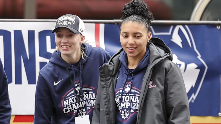 Paige Bueckers and UConn student-athlete Azzi Fudd walk onto the stage during the Final Four Champions victory parade and rally outside of the XL Center in Hartford, CT.