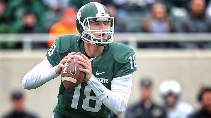 Oct 3, 2015; East Lansing, MI, USA; Michigan State Spartans quarterback Connor Cook (18) scrambles out of the pocket against the Purdue Boilermakers during the 1st quarter of a game at Spartan Stadium. Mandatory Credit: Mike Carter-Imagn Images