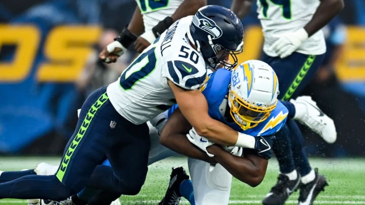 Aug 10, 2024; Inglewood, California, USA; Seattle Seahawks linebacker Patrick O'Connell (50) tackles Los Angeles Chargers running back Isaiah Spiller (28) during the fourth quarter at SoFi Stadium. Aug 10, 2024; Inglewood, California, USA; Seattle Seahawks linebacker Patrick O'Connell (50) tackles Los Angeles Chargers running back Isaiah Spiller (28) during the fourth quarter at SoFi Stadium.
