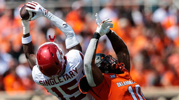 Sep 7, 2024; Stillwater, Oklahoma, USA; Arkansas Razorbacks defensive back Jaheim Singletary (15) makes an interception over Oklahoma State Cowboys wide receiver Rashod Owens (10) during the second quarter at Boone Pickens Stadium. Mandatory Credit: William Purnell-Imagn Images Sep 7, 2024; Stillwater, Oklahoma, USA; Arkansas Razorbacks defensive back Jaheim Singletary (15) makes an interception over Oklahoma State Cowboys wide receiver Rashod Owens (10) during the second quarter at Boone Pickens Stadium. Mandatory Credit: William Purnell-Imagn Images