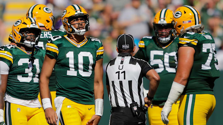 Green Bay Packers quarterback Jordan Love (10) grabs his leg after running the ball against the Minnesota Vikings during their football game Sunday, September 29, 2024, at Lambeau Field in Green Bay, Wisconsin.