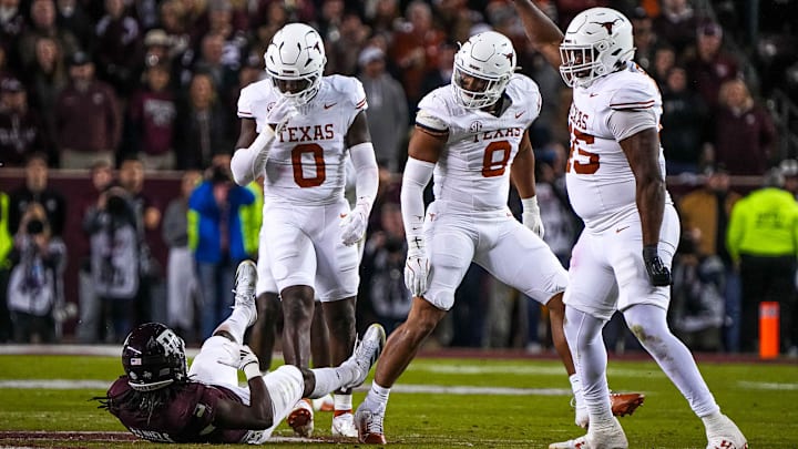 Texas Longhorns edge rusher Trey Moore (8) looks down at Texas A&M running back Amari Daniels (5) after a tackle during the Lone Star Showdown at Kyle Field on Saturday, Nov. 30, 2024 in College Station, Texas. Texas Longhorns edge rusher Trey Moore (8) looks down at Texas A&M running back Amari Daniels (5) after a tackle during the Lone Star Showdown at Kyle Field on Saturday, Nov. 30, 2024 in College Station, Texas.