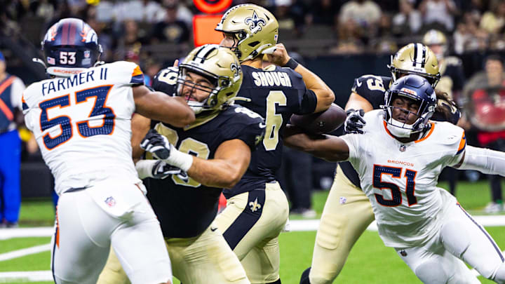Aug 23, 2025; New Orleans, Louisiana, USA; Denver Broncos linebacker Que Robinson (51) knocks the ball loose from New Orleans Saints quarterback Tyler Shough (6) during the second half at Caesars Superdome.