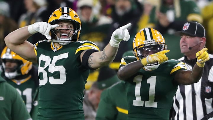 Dec 23, 2024; Green Bay, Wisconsin, USA;  Green Bay Packers wide receiver Jayden Reed (11) reacts with tight end Tucker Kraft (85) after cathing a first down pass against the New Orleans Saints at Lambeau Field. Mandatory Credit: Wm. Glasheen USA TODAY NETWORK-Wisconsin/Imagn Images