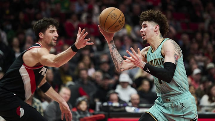 Feb 22, 2025; Portland, Oregon, USA; Charlotte Hornets guard LaMelo Ball (1) loses control of the basketball during the first half against Portland Trail Blazers forward Deni Avdija (8) at Moda Center. Mandatory Credit: Troy Wayrynen-Imagn Images