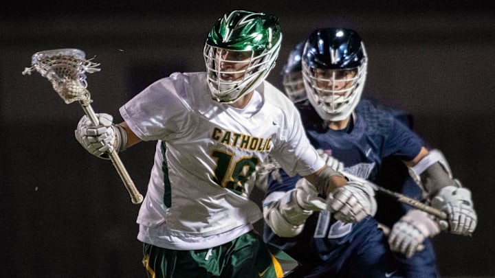 Catholic's Crawford Callahan (No. 18) presses the attack on the Gulf Breeze goal during Wednesday's rivalry match.