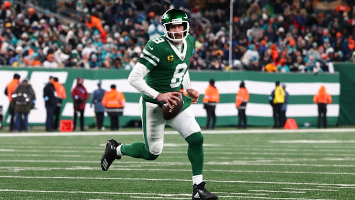 Jan 5, 2025; East Rutherford, New Jersey, USA; New York Jets quarterback Aaron Rodgers (8) runs with the ball during the third quarter of their game against the Miami Dolphins at MetLife Stadium. Mandatory Credit: Ed Mulholland-Imagn Images
