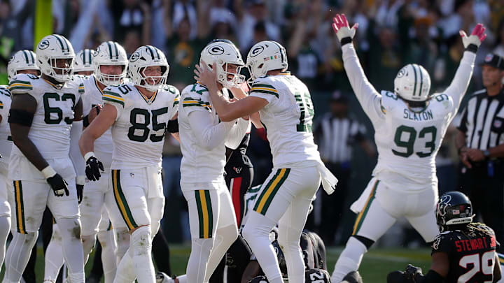Green Bay Packers place Brandon McManus (17) and holder Daniel Whelan (19) celebrate the winning field goal against Houston.