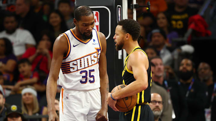 Phoenix Suns forward Kevin Durant (35) talks to Golden State Warriors guard Stephen Curry after a foul in the first half at Footprint Center. Mandatory Credit: Mark J. Rebilas-Imagn Images