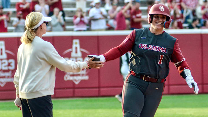 Oklahoma catcher Kendall Wells celebrates a home run with Patty Gasso.