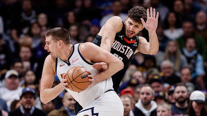 Nov 29, 2023; Denver, Colorado, USA; Denver Nuggets center Nikola Jokic (15) controls the ball as Houston Rockets center Alperen Sengun (28) defends in the first quarter at Ball Arena. Mandatory Credit: Isaiah J. Downing-Imagn Images