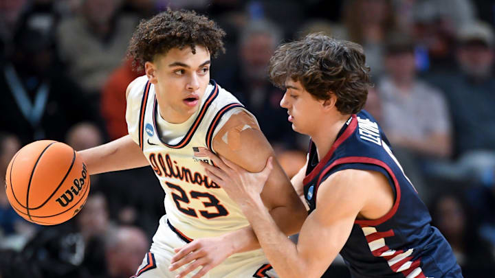Illinois Fighting Illini guard Keaton Wagler (23) is defended by Penn Quakers guard AJ Levine (0) Thursday, March 19, 2026, during the NCAA Men’s Basketball Tournament first round game at Bon Secours Wellness Arena in Greenville, South Carolina.