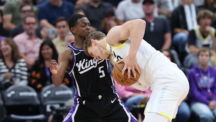 Oct 15, 2024; Salt Lake City, Utah, USA; Utah Jazz forward Lauri Markkanen (23) clears space with his head against Sacramento Kings guard De'Aaron Fox (5) during the fourth quarter at Delta Center. Mandatory Credit: Rob Gray-Imagn Images