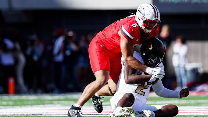 Oct 19, 2024; Tucson, Arizona, USA;  Arizona Wildcats linebacker Taye Brown (6) tackles Colorado Buffaloes quarterback Shedeur Sanders (2) during the third quarter at Arizona Stadium. Mandatory Credit: Aryanna Frank-Imagn Images