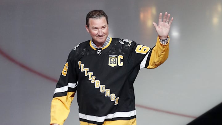 Feb 18, 2024; Pittsburgh, Pennsylvania, USA;  Pittsburgh Penguins former center Mario Lemieux waves to the crowd during a ceremony to retire the jersey number of Penguins former right wing Jaromir Jagr (not pictured) at PPG Paints Arena. The Penguins hosted the Los Angeles Kings after the ceremony. Los Angeles won 2-1. Mandatory Credit: Charles LeClaire-Imagn Images