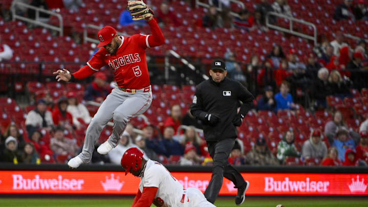 Apr 1, 2025; St. Louis, Missouri, USA; Los Angeles Angels third baseman Yoan Moncada (5) leaps over St. Louis Cardinals right fielder Jordan Walker (18) as he steals third base during the second inning at Busch Stadium. Mandatory Credit: Jeff Curry-Imagn Images
