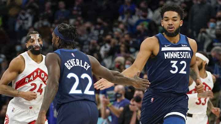 Feb 16, 2022; Minneapolis, Minnesota, USA; Minnesota Timberwolves guard Patrick Beverley (22) and center Karl-Anthony Towns (32) celebrate after a basket against the Toronto Raptors during the first quarter at Target Center.