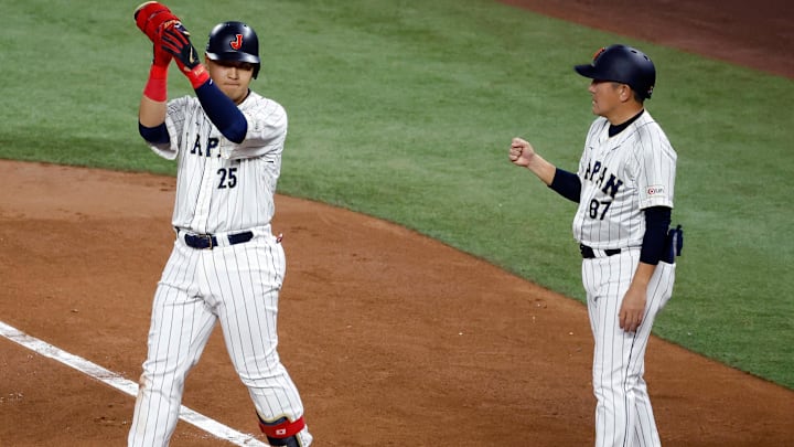 Mar 21, 2023; Miami, Florida, USA; Japan first baseman Kazuma Okamoto (25) singles against the USA in the second inning at LoanDepot Park.